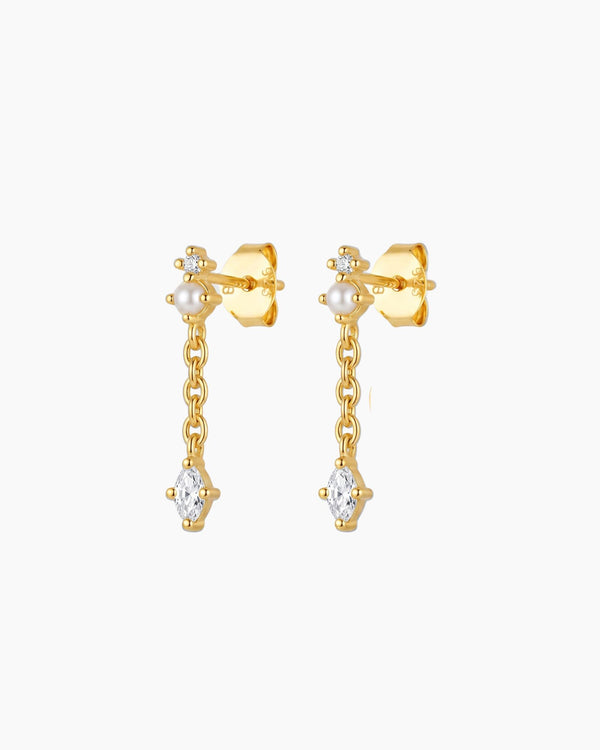18K gold plated pearl drop earrings featuring a marquise-cut cubic zirconia stone suspended from a fine chain. Feminine lightweight gold earrings for women looking for timeless everyday jewellery, bridal earrings, special occasion accessories or elegant gold pearl earrings.