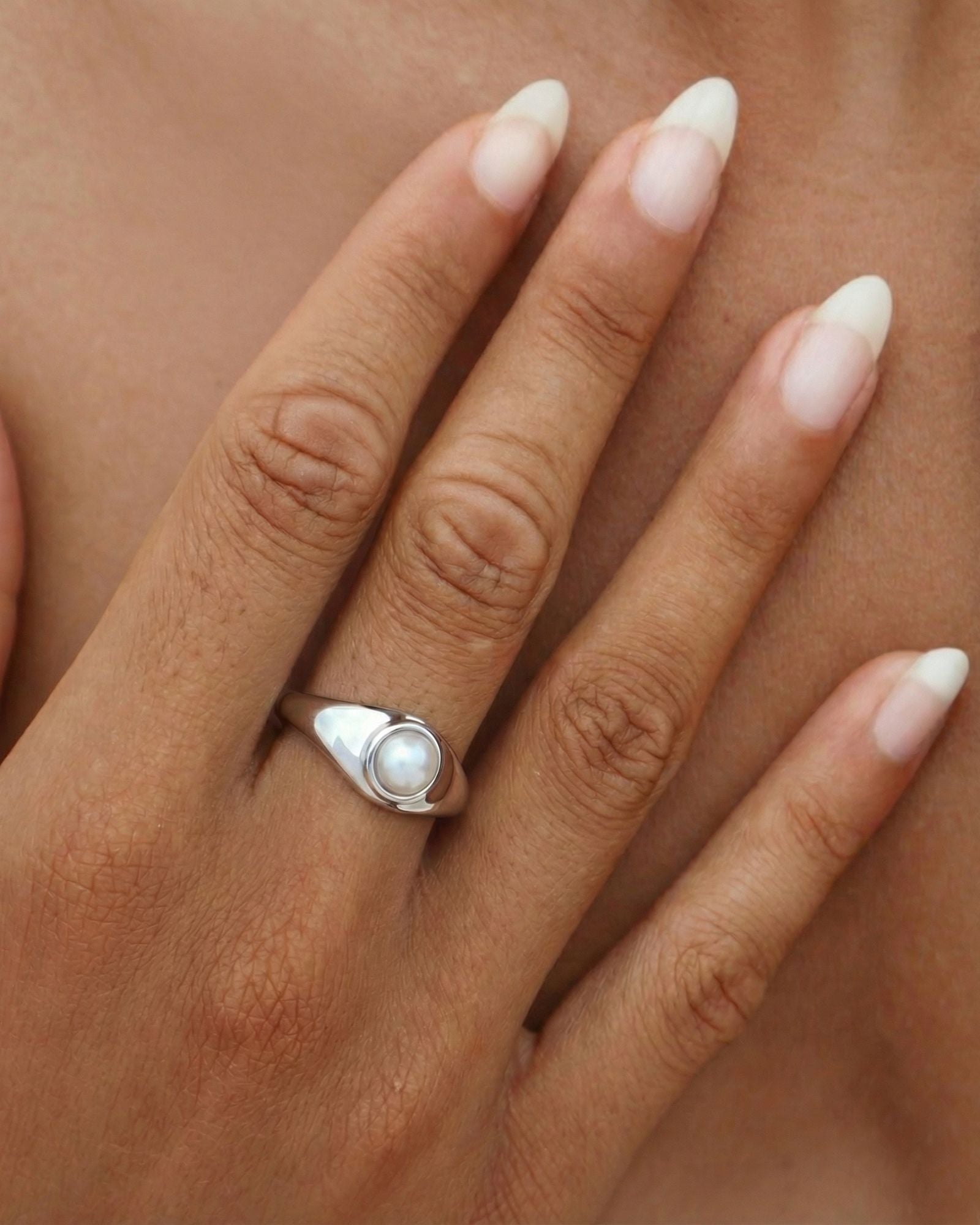 Sterling silver and gold pearl signet ring with a freshwater pearl, low-profile setting and polished minimalist band for everyday wear.