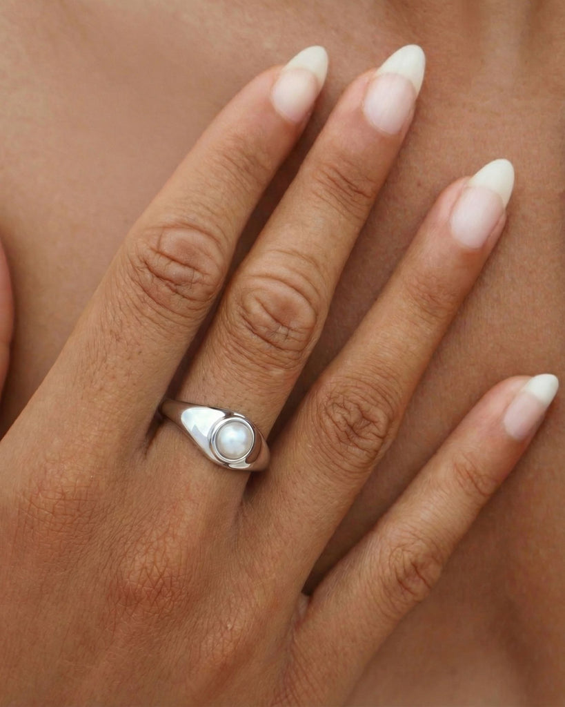 Sterling silver and gold pearl signet ring with a freshwater pearl, low-profile setting and polished minimalist band for everyday wear.