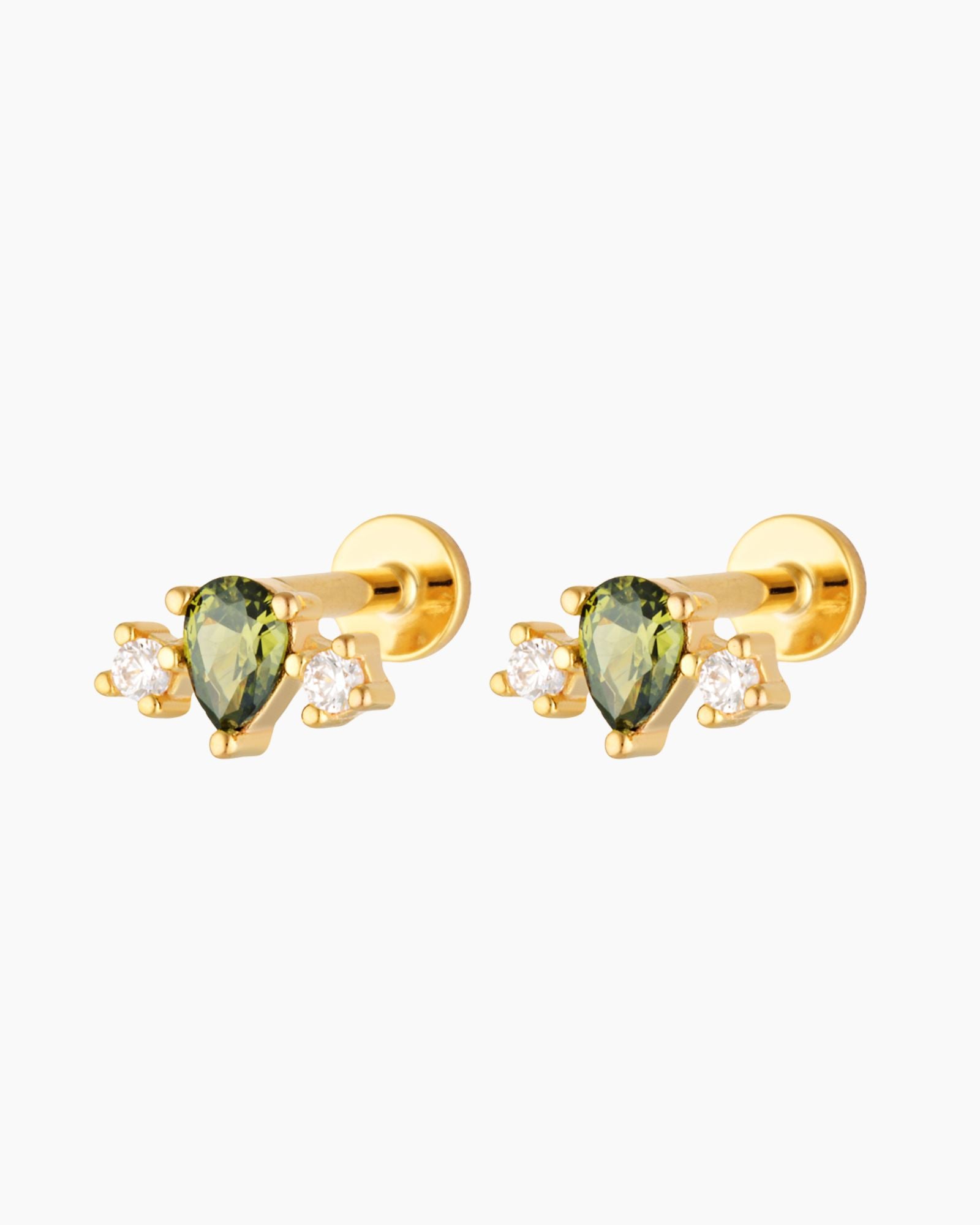 Pair of gold flat back cartilage studs featuring a green pear-cut gemstone with two cubic zirconia accents, 18k gold plated sterling silver, on a white background.