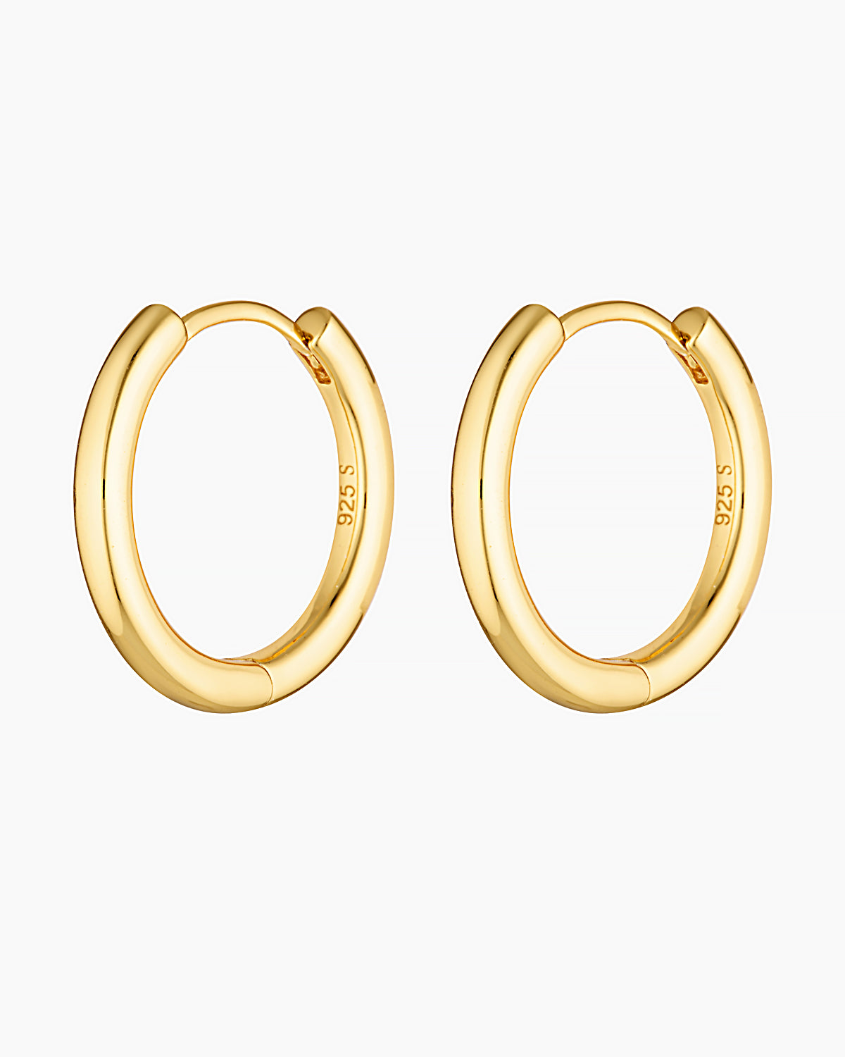 Product photo of a pair of medium-sized gold hoop earrings with a softly rounded, sculpted profile and high-polish finish, shown on a clean white background. The hoops feature a smooth hinged clasp and are stamped 925, indicating a solid sterling silver base with gold plating. Designed for women seeking elegant gold hoop earrings that feel elevated yet wearable, this image highlights refined statement hoops suitable for everyday wear, special occasions, and sensitive ears. Ideal for customers looking for 18