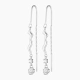 thread silver earring with organic charm with attached white gem stone and a silver nugget