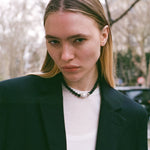 black beaded onyx neckalce with silver details with a white natural baroque pearl as a centerpiece 