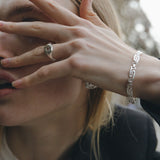 textured silver ring with white gemstone and greek inspired silver bracelet