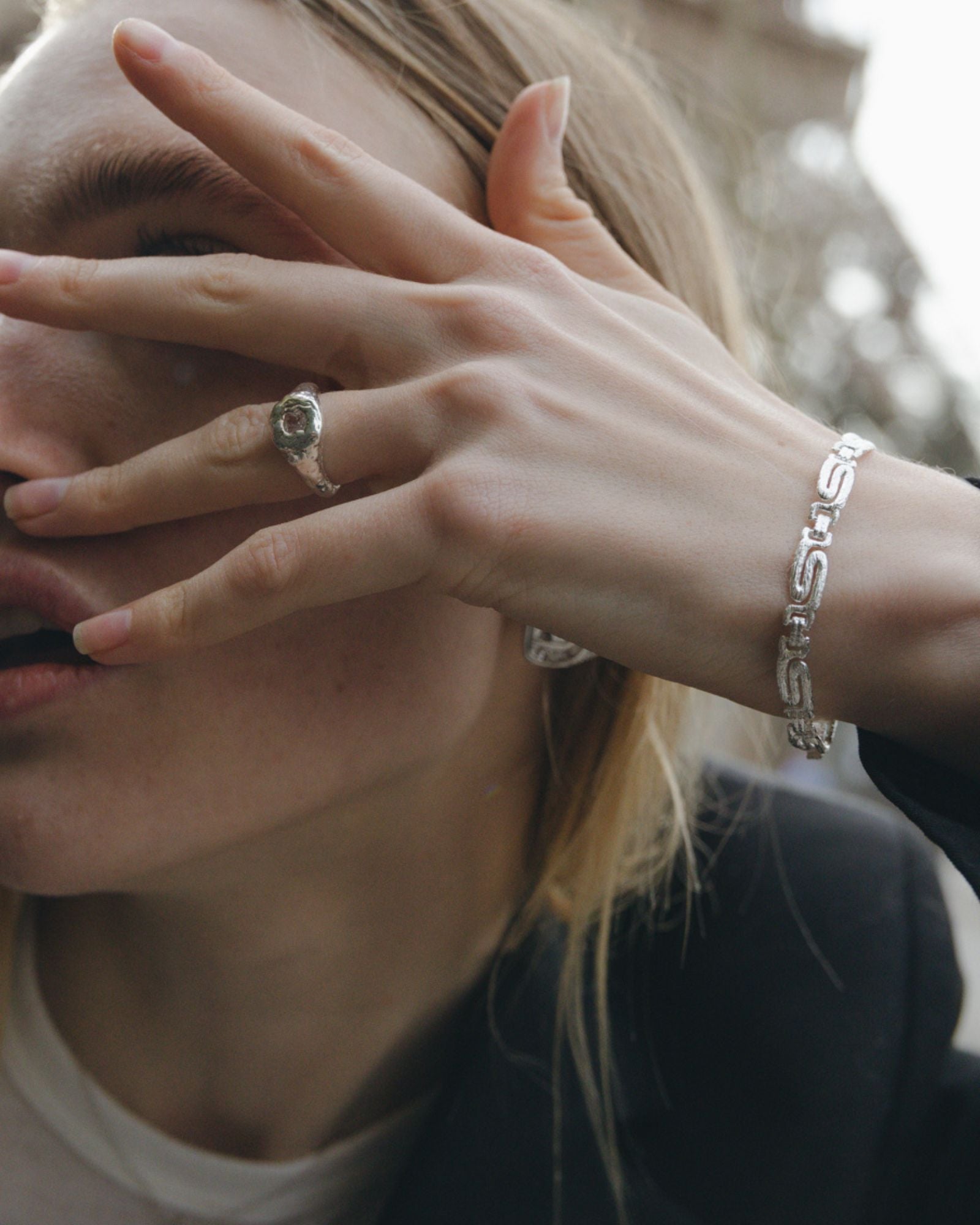 textured silver ring with white gemstone and greek inspired silver bracelet