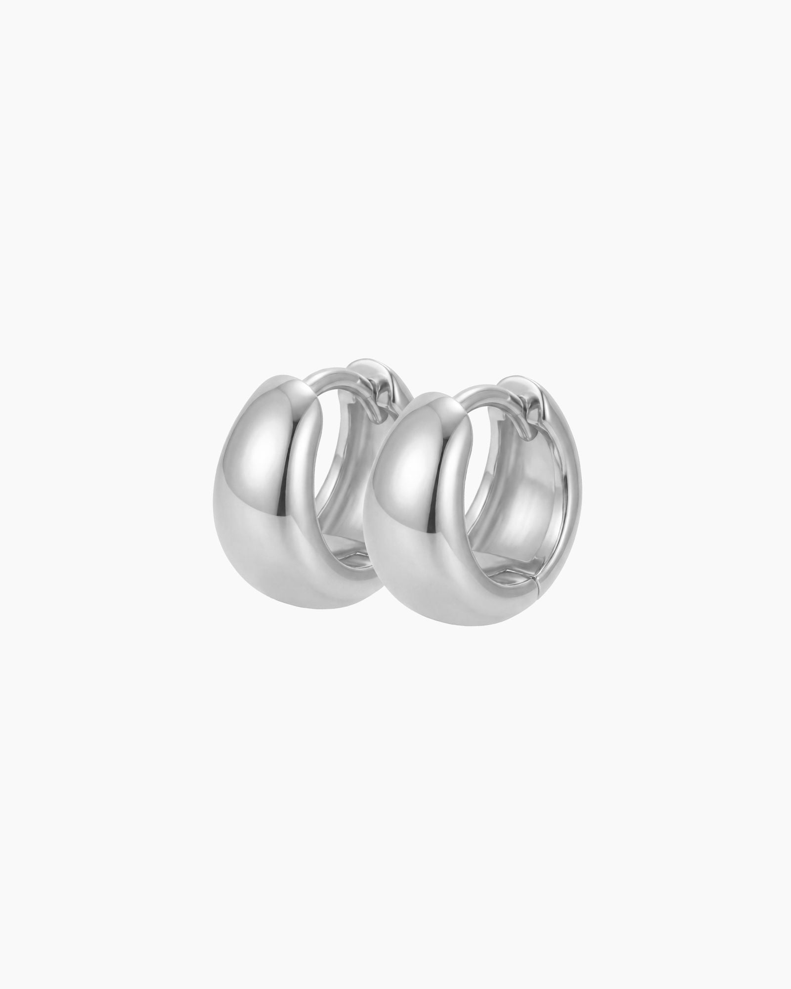 SELENE rounded silver hoop earrings on a white background featuring a polished chunky dome design. Sterling silver hoop earrings with rhodium plating, designed for lightweight everyday wear, sensitive ears, minimal jewellery styling and timeless layered looks.