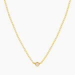 Dainty gold necklace with small cubic zirconia stone on a thin rolo chain