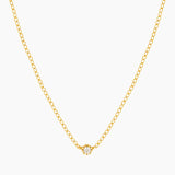 Dainty gold necklace with small cubic zirconia stone on a thin rolo chain