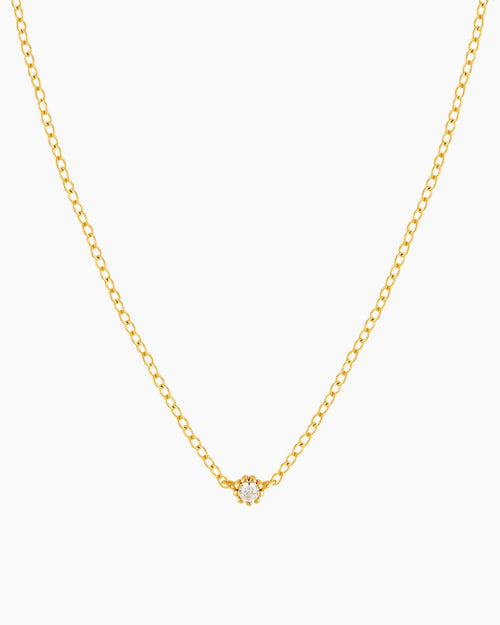 Dainty gold necklace with small cubic zirconia stone on a thin rolo chain