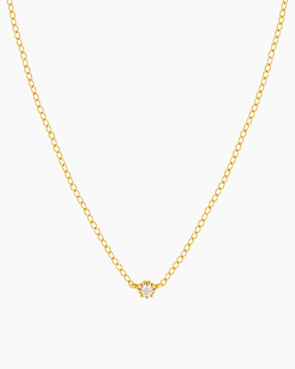 Dainty gold necklace with small cubic zirconia stone on a thin rolo chain