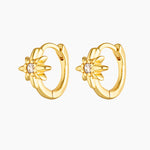 Gold huggie hoop earrings with a cubic zirconia sun charm, shown as a matching pair on a white background. Designed for women seeking small gold earrings for everyday wear, second or third piercings, and easy stacking, offering a lightweight, minimal option that adds subtle sparkle without irritation for sensitive ears.