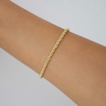 Gold-filled rope chain bracelet shown on wrist, minimal fine jewellery piece photographed against a soft neutral background.