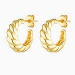 Pair of small twisted gold hoop earrings shown on a white background, featuring a sculptural rope-style design with a polished 18K gold finish and stud backings. Designed for women seeking minimalist gold hoop earrings that add subtle texture and shine for everyday wear, sensitive ears, and effortless styling from casual outfits to elevated looks.