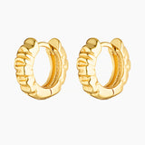 Pair of Xanthe textured gold huggie hoop earrings on a white background, featuring a sculptural rippled wave design. Designed for women seeking small gold hoop earrings that add subtle statement and texture to everyday styling, ear stacks, and huggie piercings. Ideal for those looking for lightweight, vintage-inspired gold hoops with a refined finish for daily wear.