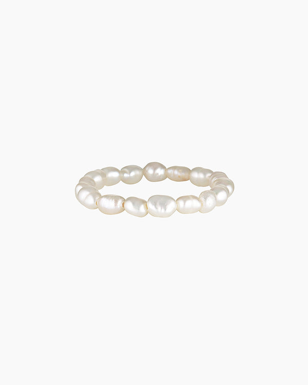 Minimalist freshwater pearl ring band made with natural white pearls arranged in a continuous circle on a clean white background. Designed for women seeking a lightweight, elegant pearl ring for everyday wear that offers a timeless, comfortable alternative to traditional metal rings.