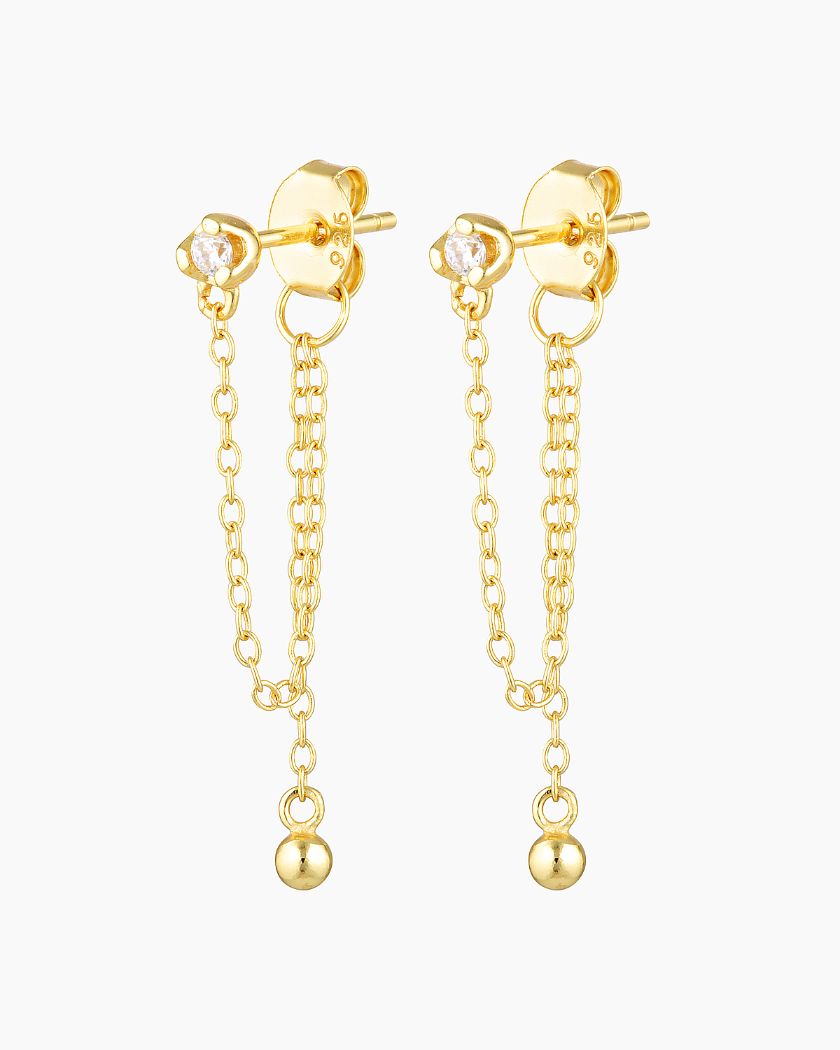 Gold chain stud earrings with a delicate 2mm clear stone and fine double chain drop ending in a polished gold bead, photographed on a white background. Designed for women seeking minimalist gold earrings that add subtle movement and elegance to everyday wear, layering, and curated ear stacks. Ideal for those looking for lightweight, hypoallergenic stud earrings that elevate simple outfits without feeling heavy or overstated.