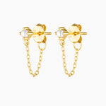 Studio product image of the Assana pearl stud earrings in gold, featuring small white pearl studs set on a solid sterling silver base with long-lasting 18k micron gold plating and a delicate gold chain connecting the stud to the butterfly backing. Designed for adults seeking minimalist pearl earrings, chain stud earrings, or hypoallergenic gold jewellery for sensitive ears, these earrings offer a secure, lightweight option that adds subtle movement and elegance to everyday wear, layered ear stacks, and refi
