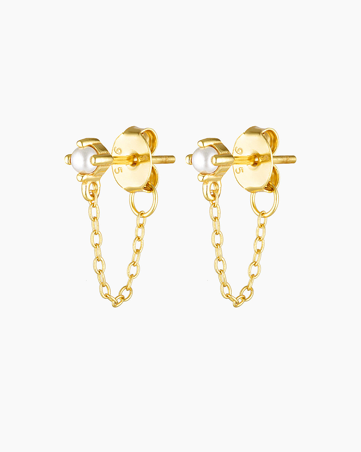 Studio product image of the Assana pearl stud earrings in gold, featuring small white pearl studs set on a solid sterling silver base with long-lasting 18k micron gold plating and a delicate gold chain connecting the stud to the butterfly backing. Designed for adults seeking minimalist pearl earrings, chain stud earrings, or hypoallergenic gold jewellery for sensitive ears, these earrings offer a secure, lightweight option that adds subtle movement and elegance to everyday wear, layered ear stacks, and refi