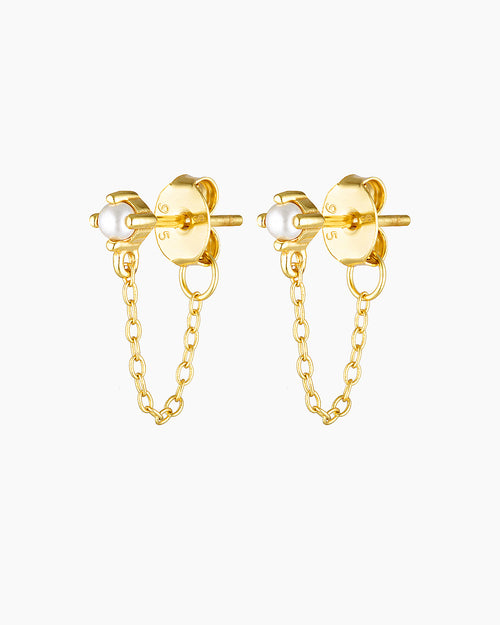Studio product image of the Assana pearl stud earrings in gold, featuring small white pearl studs set on a solid sterling silver base with long-lasting 18k micron gold plating and a delicate gold chain connecting the stud to the butterfly backing. Designed for adults seeking minimalist pearl earrings, chain stud earrings, or hypoallergenic gold jewellery for sensitive ears, these earrings offer a secure, lightweight option that adds subtle movement and elegance to everyday wear, layered ear stacks, and refi