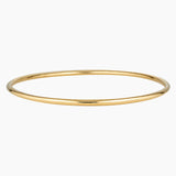 Minimalist slim gold bangle bracelet photographed on a white background, featuring a smooth polished finish and thin circular profile in 14K gold filled. Designed for women seeking a timeless everyday gold bracelet that layers easily with other bangles or can be worn alone for a clean, understated look. Ideal for those looking for durable, low-maintenance gold jewellery that is water safe, lightweight, and suitable for daily wear.