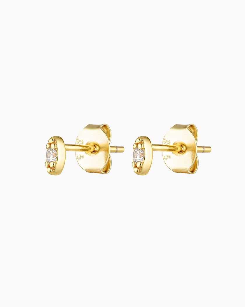 A pair of gold-plated stud earrings with a solid sterling silver base, featuring a tiny cubic zirconia stone in the center.