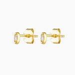 A pair of gold-plated stud earrings with a solid sterling silver base, featuring a tiny cubic zirconia stone in the center.