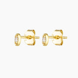 A pair of gold-plated stud earrings with a solid sterling silver base, featuring a tiny cubic zirconia stone in the center.