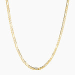 Gold Figaro chain necklace photographed on a clean white background, featuring classic alternating long and short links in a polished gold finish. Designed for women seeking a timeless gold chain necklace for everyday wear, layering, or minimalist styling. Ideal for customers looking for a durable, water-safe gold-filled Figaro necklace that adds effortless elegance to daily outfits and curated necklace stacks.