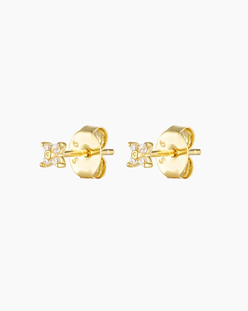 A pair of small, dainty flower earrings with a gold plating and white zirconia crystals, designed for sensitive skin.