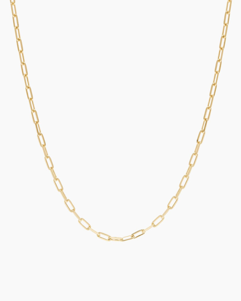 Product-only image of a gold rectangular link chain necklace displayed in a smooth U-shape against a clean white background. The oversized gold link design highlights a minimalist gold chain choker with a structured, modern silhouette. Designed for women seeking a versatile gold link necklace that adds polish to everyday outfits and solves the need for a bold yet wearable layering piece.