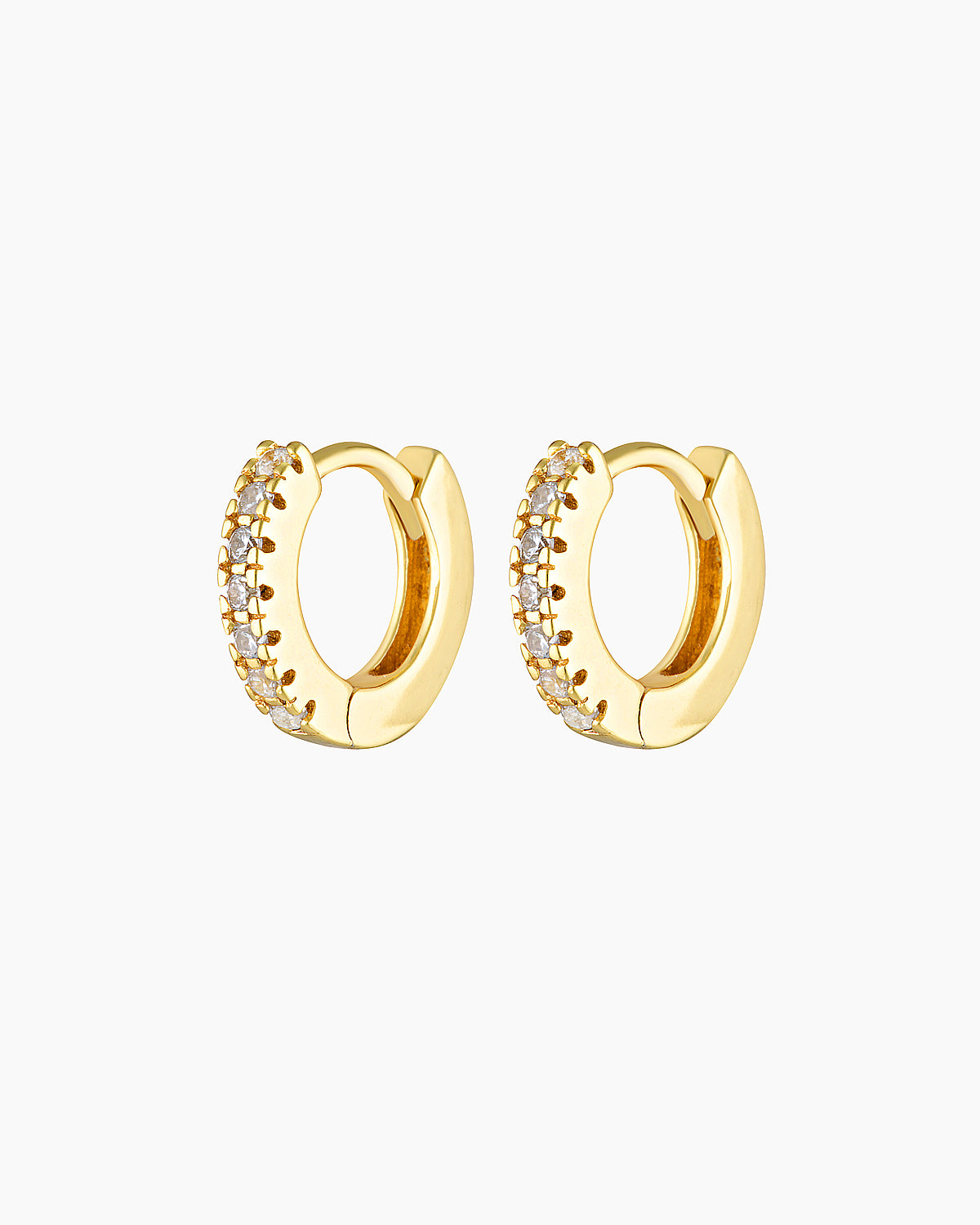 Pair of small gold huggie hoop earrings with a click-lock closure, set with clear cubic zirconia stones along the front, photographed on a white background. Designed for women seeking dainty gold hoop earrings, secure everyday huggies, and stackable earrings for second or third lobe, helix, or cartilage piercings, offering subtle sparkle without bulk or discomfort.