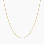 Product-only image of a delicate singapore rope rope chain necklace displayed in a U-shape against a clean white background. The fine twisted chain design highlights a lightweight, minimalist gold necklace suitable for everyday wear or layering with other necklaces. Designed for women seeking a simple, versatile gold chain that complements any outfit and solves the need for an easy, timeless base layer for jewellery stacking or standalone wear.