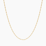 Product-only image of a delicate singapore rope rope chain necklace displayed in a U-shape against a clean white background. The fine twisted chain design highlights a lightweight, minimalist gold necklace suitable for everyday wear or layering with other necklaces. Designed for women seeking a simple, versatile gold chain that complements any outfit and solves the need for an easy, timeless base layer for jewellery stacking or standalone wear.