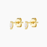 Close-up product image of the Netro gold stud earrings featuring marquise-cut clear gemstones set in a minimalist prong setting, crafted on a solid sterling silver base with long-lasting 18k micron gold plating and butterfly backs. Designed for women seeking timeless gold stud earrings, marquise studs, or hypoallergenic earrings for sensitive ears, these lightweight studs are ideal for everyday wear, first or second piercings, and refined ear stacking without irritation.