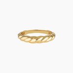 Slim twisted gold ring photographed on a clean white background, showing the Odette gold ring’s croissant-inspired design and polished finish. Designed for women seeking a minimalist gold stacking ring for everyday wear, this image highlights a durable 14K gold-filled twisted band that solves the need for a timeless, low-maintenance ring that layers easily or stands alone.