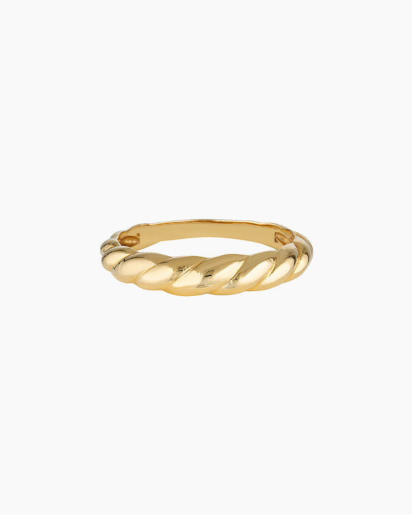 Slim twisted gold ring photographed on a clean white background, showing the Odette gold ring’s croissant-inspired design and polished finish. Designed for women seeking a minimalist gold stacking ring for everyday wear, this image highlights a durable 14K gold-filled twisted band that solves the need for a timeless, low-maintenance ring that layers easily or stands alone.