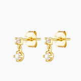 Gold pearl and cubic zirconia stud earrings shown on a white background, featuring a small crystal stud with a dangling freshwater pearl charm in polished 18k gold plating. Designed for women seeking elegant pearl stud earrings that are lightweight, hypoallergenic, and suitable for everyday wear, work, weddings, and sensitive ears, offering a refined solution for minimalist styling and timeless jewellery layering.