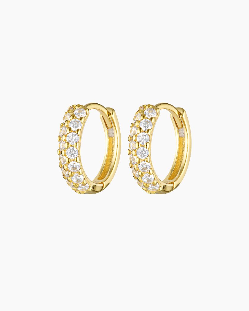 Studio product image of Tia crystal gold hoop earrings featuring small round hoops set with rows of clear cubic zirconia stones on a polished gold finish. Designed for women seeking lightweight, hypoallergenic gold hoop earrings that add refined sparkle for everyday wear, sensitive ears, and effortless ear stacking.