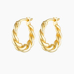 Product-only image of a pair of twisted gold hoop earrings with a polished, semi-bold braided design and a hinged clasp, shown on a white background. These gold hoop earrings are designed for people seeking medium-sized statement hoops that remain lightweight and comfortable, offering an elevated everyday option that adds texture and impact without overpowering minimalist or layered ear styling.