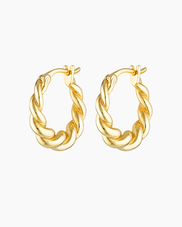 Product-only image of a pair of twisted gold hoop earrings with a polished, semi-bold braided design and a hinged clasp, shown on a white background. These gold hoop earrings are designed for people seeking medium-sized statement hoops that remain lightweight and comfortable, offering an elevated everyday option that adds texture and impact without overpowering minimalist or layered ear styling.